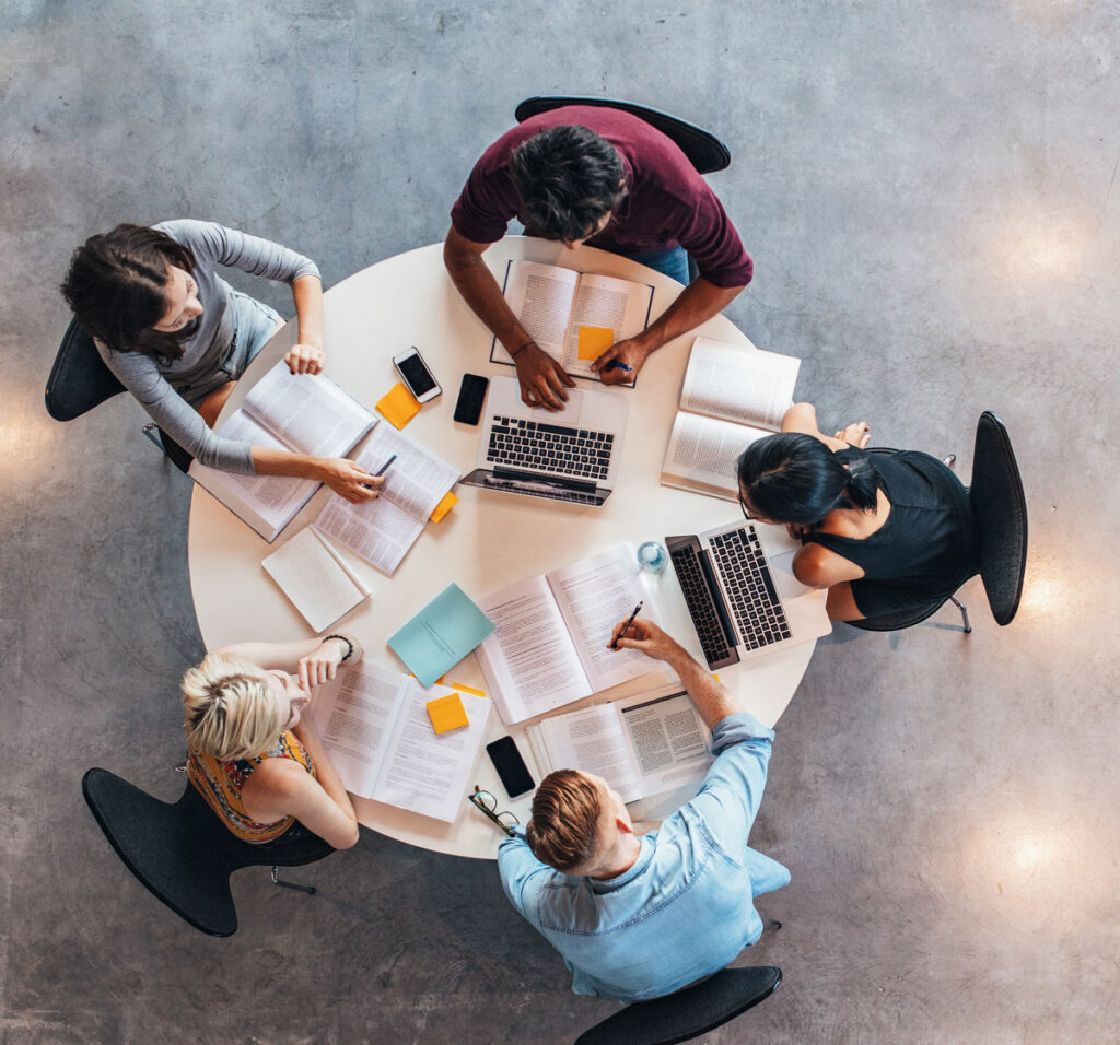 Students sitting around a table studying.